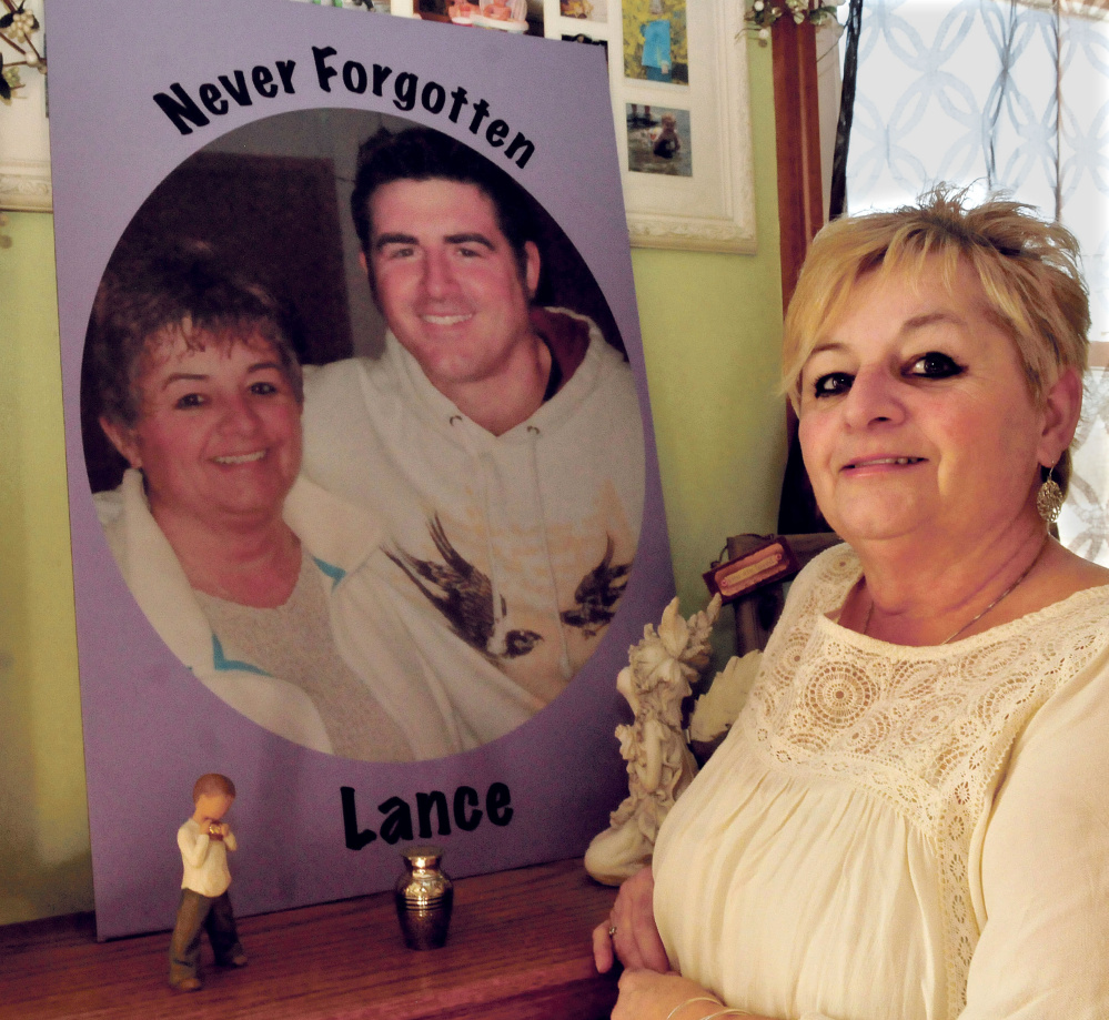Ruth Perkins on Thursday stands beside a painting of herself and her son Lance made two years ago. Lance died of a drug overdose in April 2015.