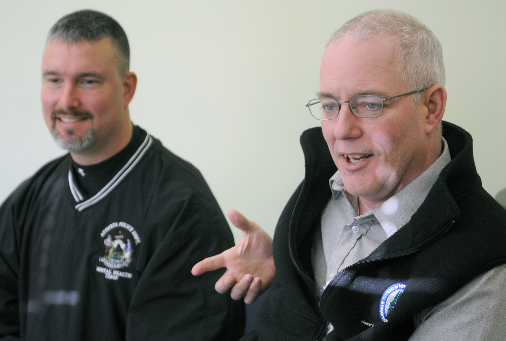 Augusta Police Chief Robert Gregoire, right, and crisis worker Greg Smith expressed concern about the availability of funding for Smith’s position at the police station Wednesday in Augusta.