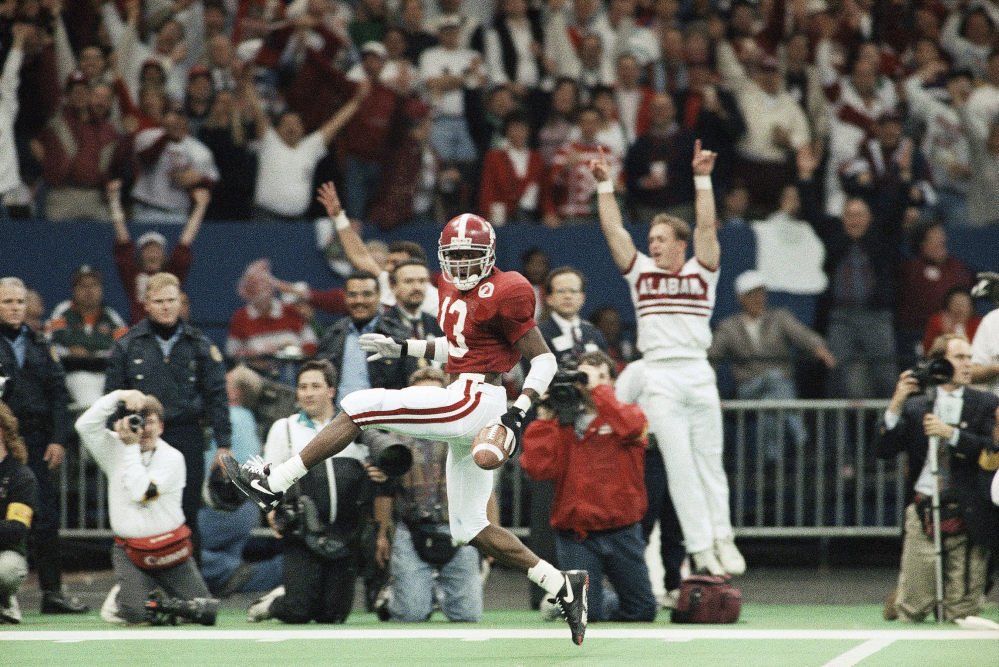 Alabama free safety George Teague dances his way into the end zone with a touchdown off an intercepted pass by Miami’s Gino Torretta during the third quarter of the 1993 Sugar Bowl in New Orleans. The first title game chosen by the Bowl Coalition matched near-unanimous No. 1 Miami against Alabama. Both teams were undefeated, with Miami going for its second straight title and favored by eight points. But Alabama won its first national title since 1979, with a 34-13 win.