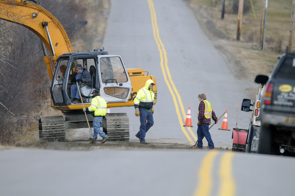 Crews repair South Monmouth Road in Monmouth on Monday after a culvert washed out during heavy rain on Sunday.