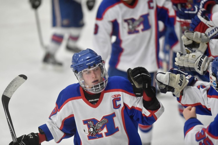 Messalonskee forward Jared Cunningham, left, celebrates his second period goal with teammates during a Dec. 15 game at Sukee Arena in Winslow. Cunningham is just two points away from tying the program’s scoring record held by older brother Chase.