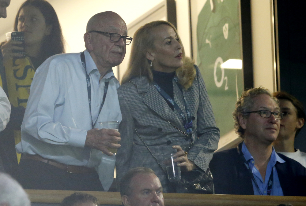 In this file photo, media mogul Rupert Murdoch stands with model Jerry Hall during the Rugby World Cup final between New Zealand and Australia at Twickenham Stadium, London.