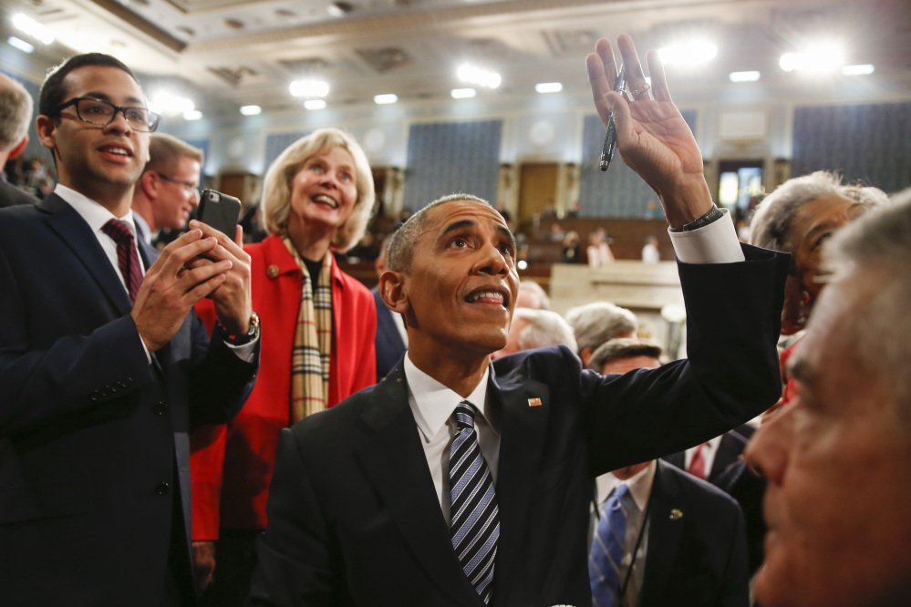 President Barack Obama waves as he walks back up the aisle at conclusion of his State of the Union address to a joint session of Congress on Capitol Hill in Washington, Tuesday.