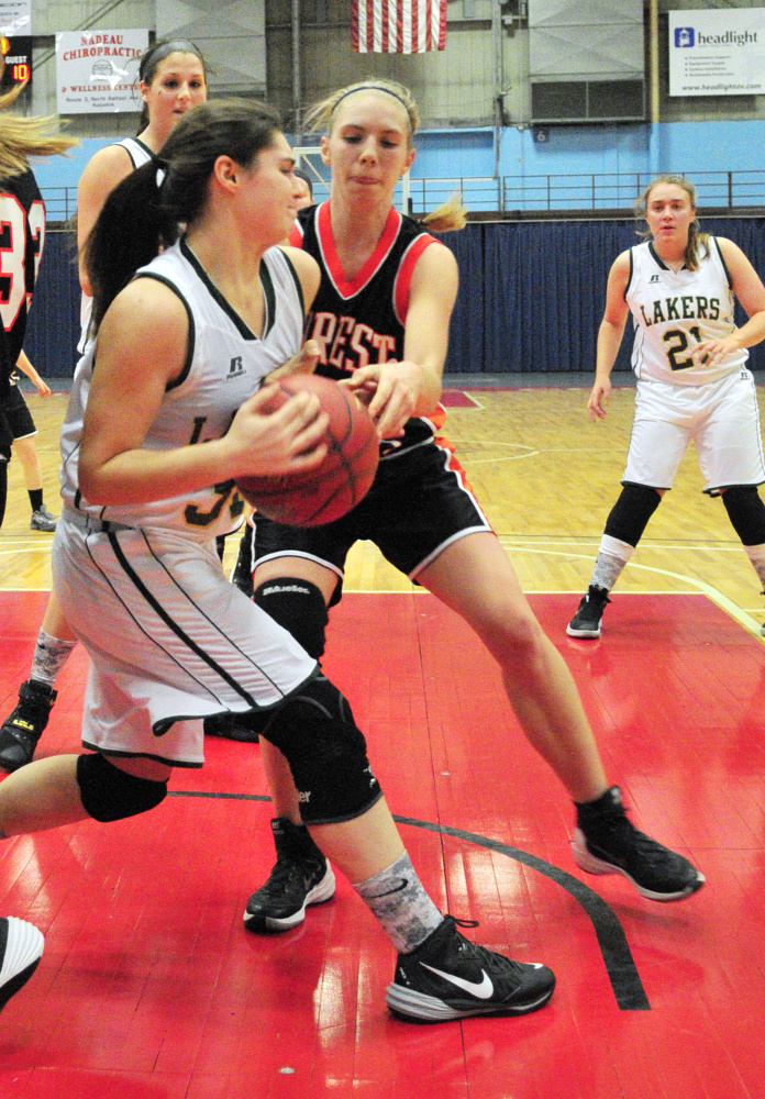 Rangeley’s Sydney Royce, left, and Forest Hills’ Caitlin Logston battle for rebound during a Dec. 31 game in the Augusta Civic Center. Royce, a sophomore, starts for the fast-charing Lakers.