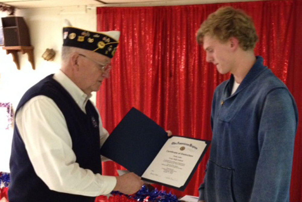 Fitzgerald-Cummings Post 2 Commander Pat Eisenhart presents a scholarship and certificate of distinction to Cony High School senior Noah Aube.