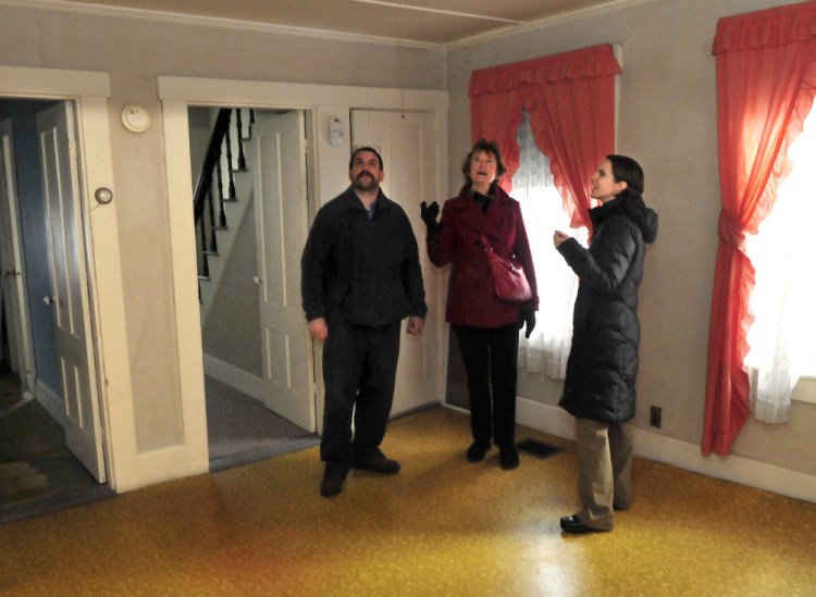 Members of the Waterville Community Land Trust, including Scott McAdoo, Vice President Nancy Williams, center, and President Ashley Pullen, on Tuesday look over the inside of the first home that will be made available through the trust as affordable housing at 181 Water St. in Waterville on Tuesday.