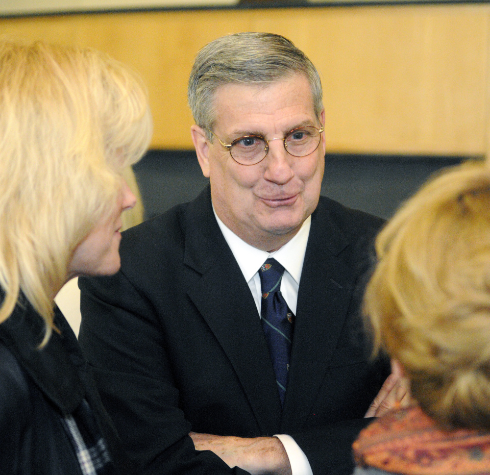 James Conneely talks to people at reception after being introduced as the new president of University of Maine at Augusta in December in the Fireplace Lounge of Randall Hall on the University of Maine at Augusta campus.
