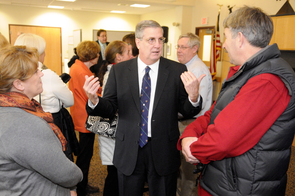 James Conneely, the new president at the University of Maine at Augusta, speaks with people attending the announcement of his appointment in December at the UMA campus.