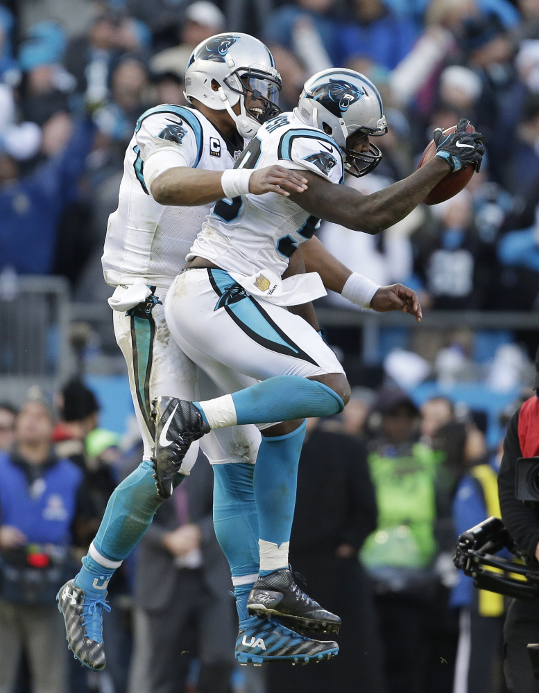 Carolina Panthers quarterback Cam Newton (1) celebrates with Carolina Panthers outside linebacker Thomas Davis (58) after Davis caught the onside kick made by Seattle Seahawks during the second half of an NFL divisional playoff football game, Sunday, Jan. 17, 2016, in Charlotte, N.C. The Panthers won 31-24. (AP Photo/Bob Leverone)