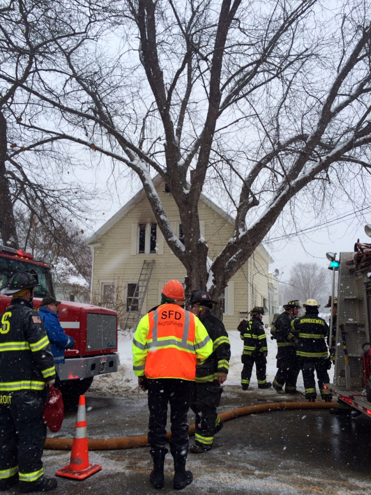 Firefighters battle a blaze at 88 Old Point Ave. in Madison on Monday afternoon.