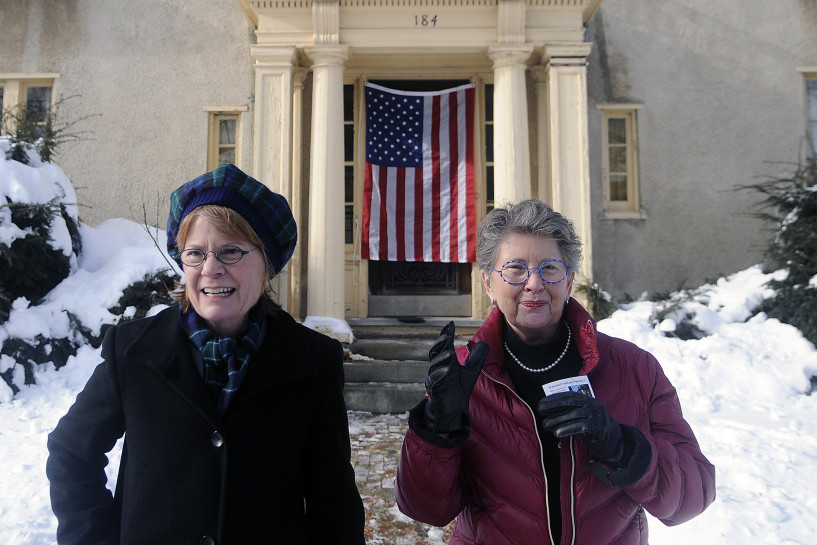 Genie, left, and Terry Gannett Hopkins exit the Gannett House in Augusta Tuesday after unveiling the colors on the entrance following an announcement by the heirs of publisher Guy Gannett that the former state office building will be converted into a First Amendment museum.