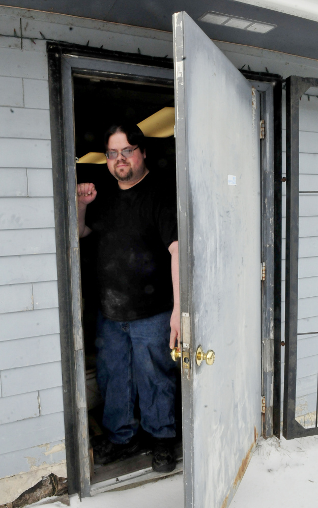 Brandon Pomelow, owner of Jim’s Variety store in Athens, on Tuesday, stands inside the entrance door where a thief or thieves broke into to steal $1,500 worth of tobacco products overnight Saturday into Sunday.