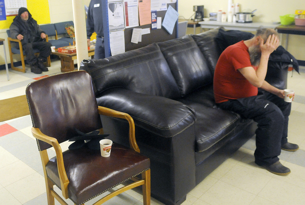 Craig Dorr, of Augusta, right, rubs his eyes Tuesday at the Augusta Community Warming Center before heading home.