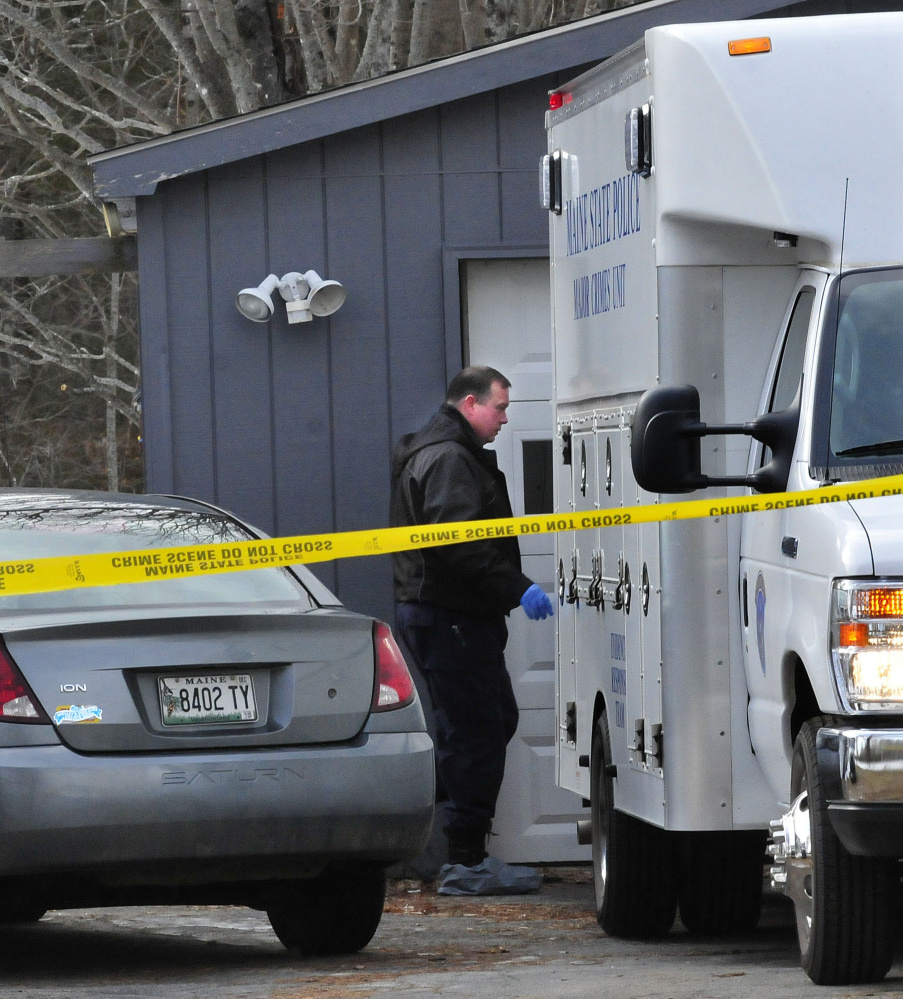 A state police investigator enters the rear of the Major Crimes Unit while conducting an investigation at 457 Norridgewock Road in Fairfield on Jan. 12.