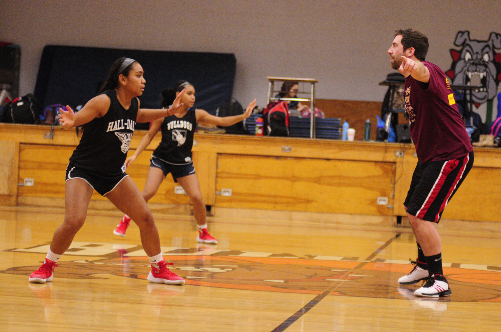 Thea Sweet, left, and Dani Sweet run drills in front of Hall-Dale coach Jarod Richmond on Tuesday in Penny Memorial Gym in Farmingdale.