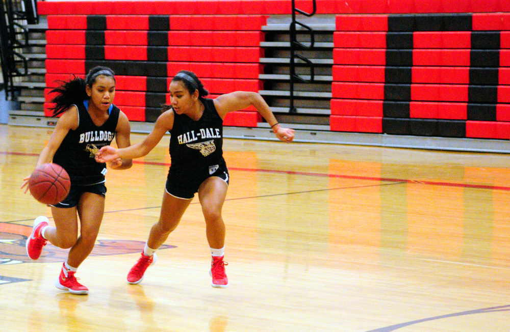 Dani Sweet, left, tries to get past sister Thea during practice Tuesday at Hall-Dale's Penny Memorial Gym in Farmingdale.