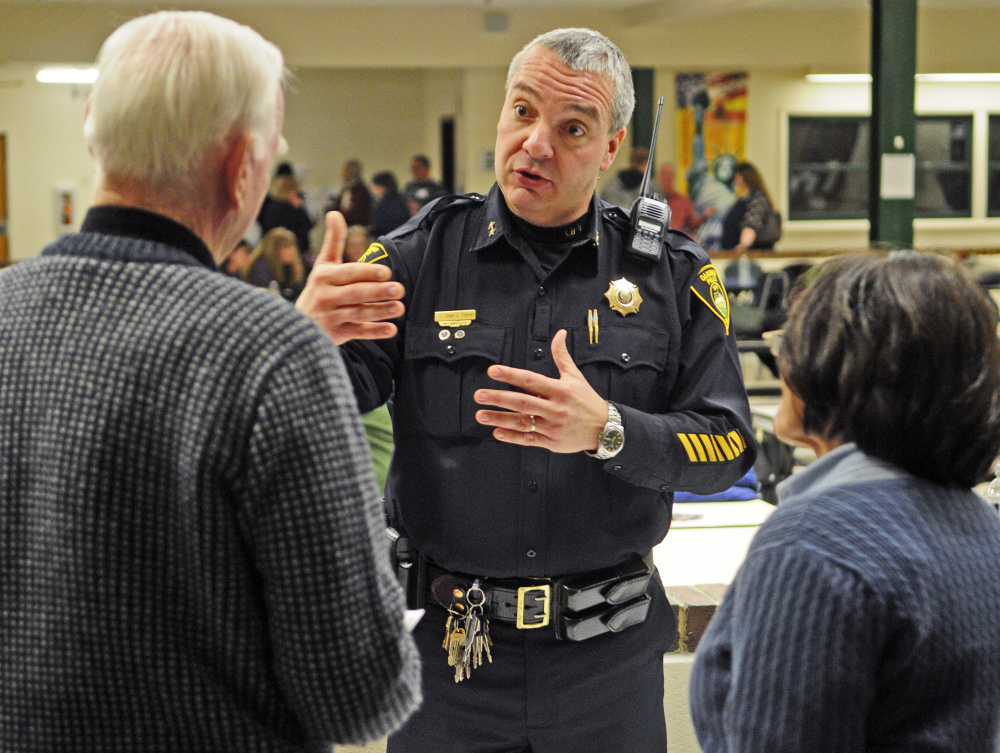 Gardiner police Chief Jim Toman talks to people visiting the intervention information tables Thursday during the Opiates in Gardiner event at Gardiner Regional Middle School.