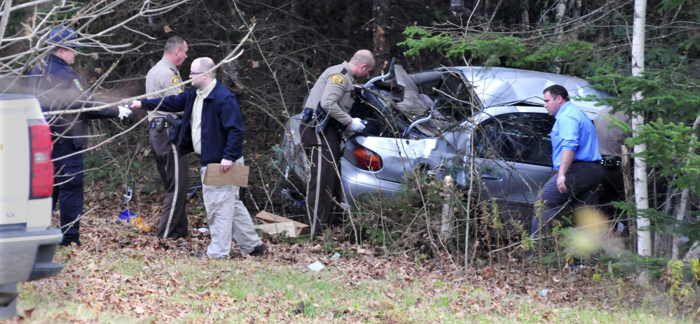 Somerset, state and Skowhegan police remove evidence from the wreckage of the car that Robert Tucker was driving during a police chase that started in Skowhegan and ended when the car left the Huff Road in Cornville and crashed into trees on Nov. 2. Tucker was indicted by a Somerset County grand jury on a number of charges this week.