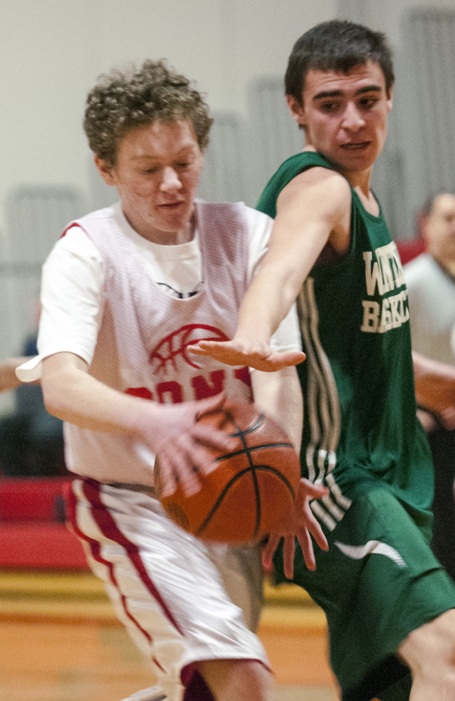 Cony’s Aaron Gray, left, tries to get past a Winthrop defender during a unified basketball game Friday at Cony High in Augusta.