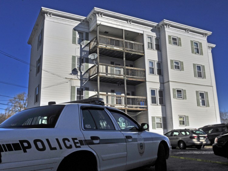 A police car sits in the parking lot at 75 Washington St. on Nov. 24, 2015 in Augusta where Joseph Marceau, 31, of Augusta was killed, according to police.