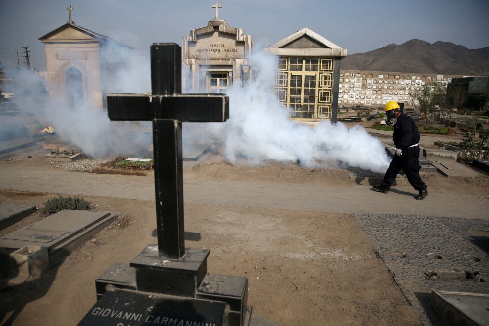 A health worker fumigates to prevent Dengue, Chikunguya and Zika virus, at El Angel cemetery, in Lima, Peru.