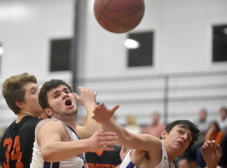 Waterville’s Justin Kornsey, center, and Michael Nigro, right, look to grab a rebound as Skowhegan’s Garrett McSweeney closes in on the play during a Kennebec Valley Athletic Conference Class A game Tuesday night in Waterville.