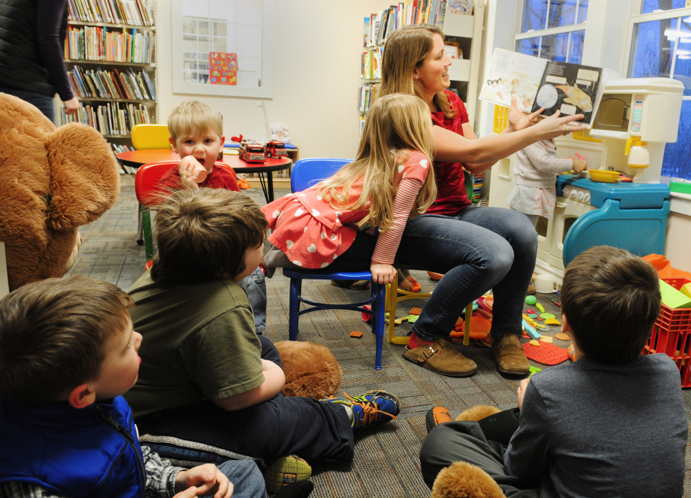 Volunteer Missy Dore reads to children during story hour on Tuesday at Umberhine Library in Richmond. Dore organized the GoFundMe page to raise money after a recent robbery at the Richmond library.