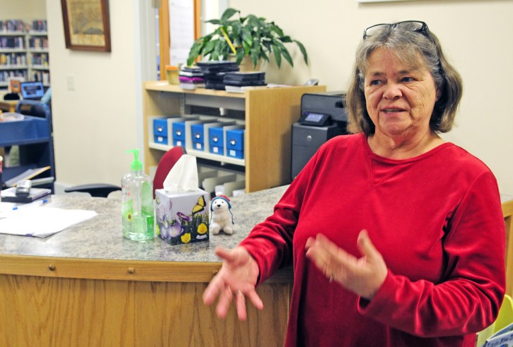Librarian Donna McCluskey talks Tuesday about the donation jar that had been taken from the counter in a recent robbery at the Isaac F. Umberhine Public Library in Richmond.