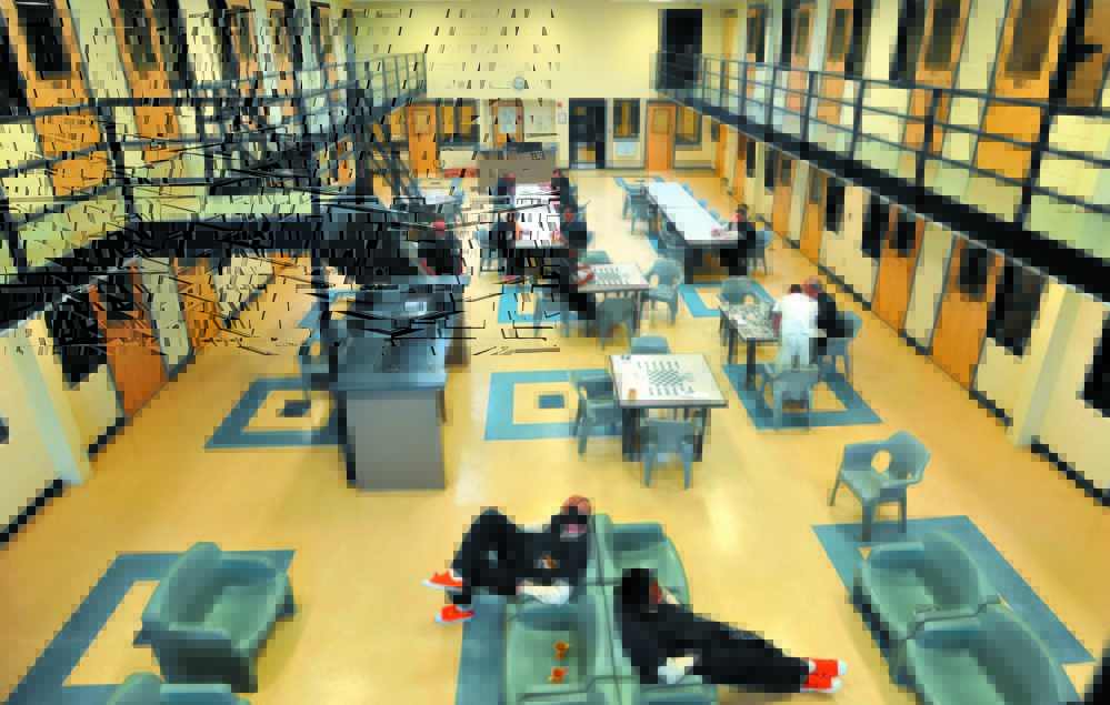 Inmates read and play board games in the day room in the medium security wing at the Somerset County Jail in East Madison in 2014. A suit brought by the girlfriend of an inmate who died at the jail that year, Joseph Dauost, is being settled for nearly $2 million.