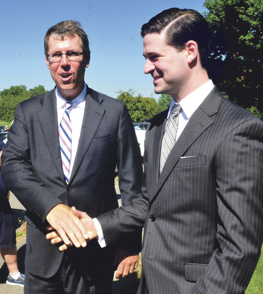 Kevin Mattson, left, owner of Dirigo Capital Advisors, greets Waterville Mayor Nick Isgro during a groundbreaking ceremony for Woodfords Family Services in Waterville on Sept. 15. Mattson said Wednesday that construction on the building, adjacent to the former Seton hospital building on Chase Avenue, will begin in April.