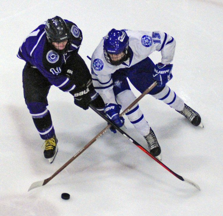 Waterville’s Jackson Aldrich, left, and Lewiston’s Jean-Luc Dostie battle for control of the puck during a game Wednesday at Androscoggin Bank Colisée in Lewiston.