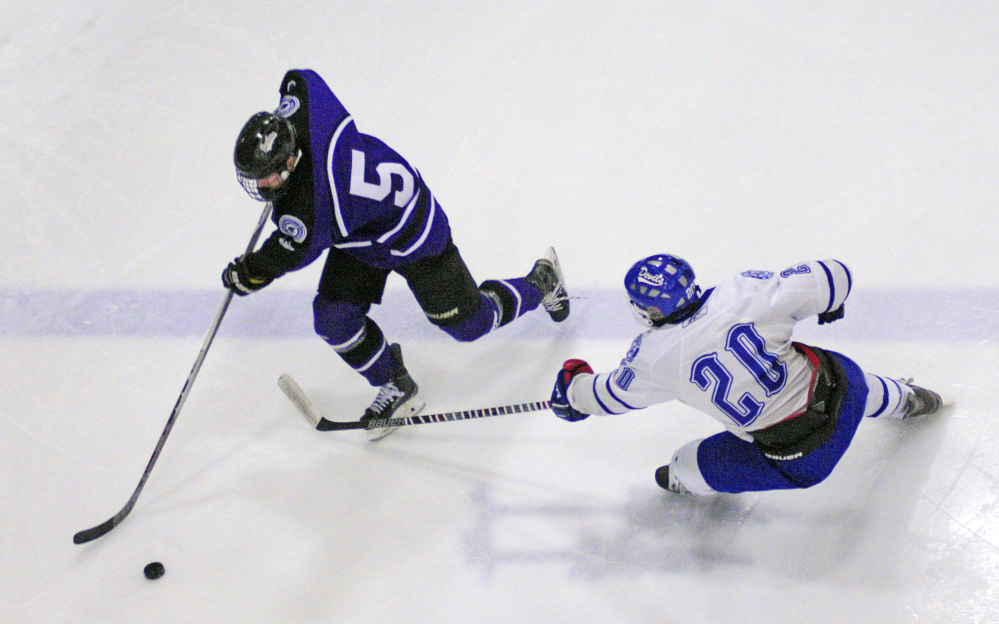 Waterville’s Andrew Roderigue, left, tries to get past Lewiston defender Kyle Morin during a game  Wednesday at Androscoggin Bank Colisee in Lewiston.