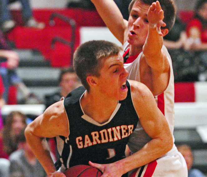 Gardiner’s Eli Fish, left, looks for a teammate to pass to as Cony’s Nate Parlin plays tight defense earlier this season at Cony High in Augusta.