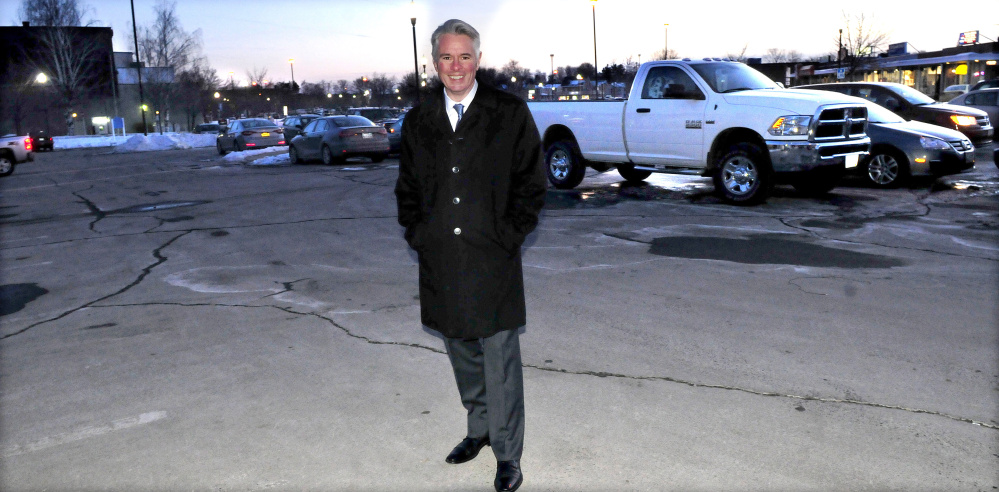 Colby College President David Greene stands inside the Concourse parking lot in Waterville Monday, which the college hopes to buy from the city for $300,000. If the City Council agrees to the sale, the college would build a dormitory with first-floor commercial space, which would be owned by someone other than the college.
