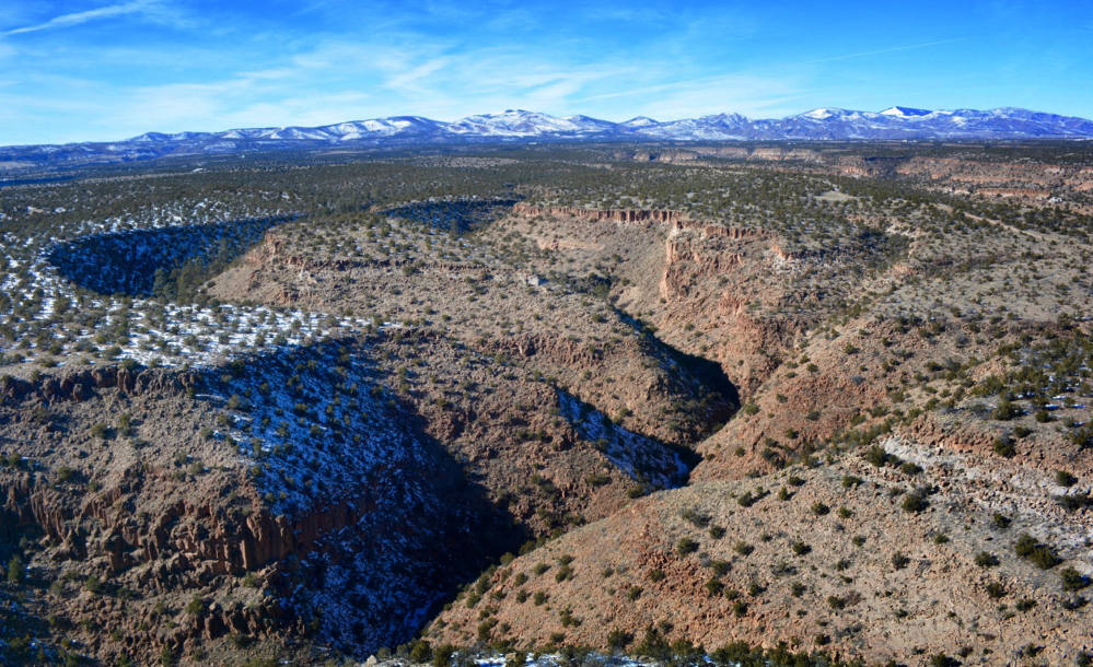 This Tuesday, Jan. 26, 2015 photo provided by Cynthia Meachum shows an areal view of the terrain where a search of treasure hunter Randy Bilyeu, went  missing along Rio Grande in northern New Mexico.