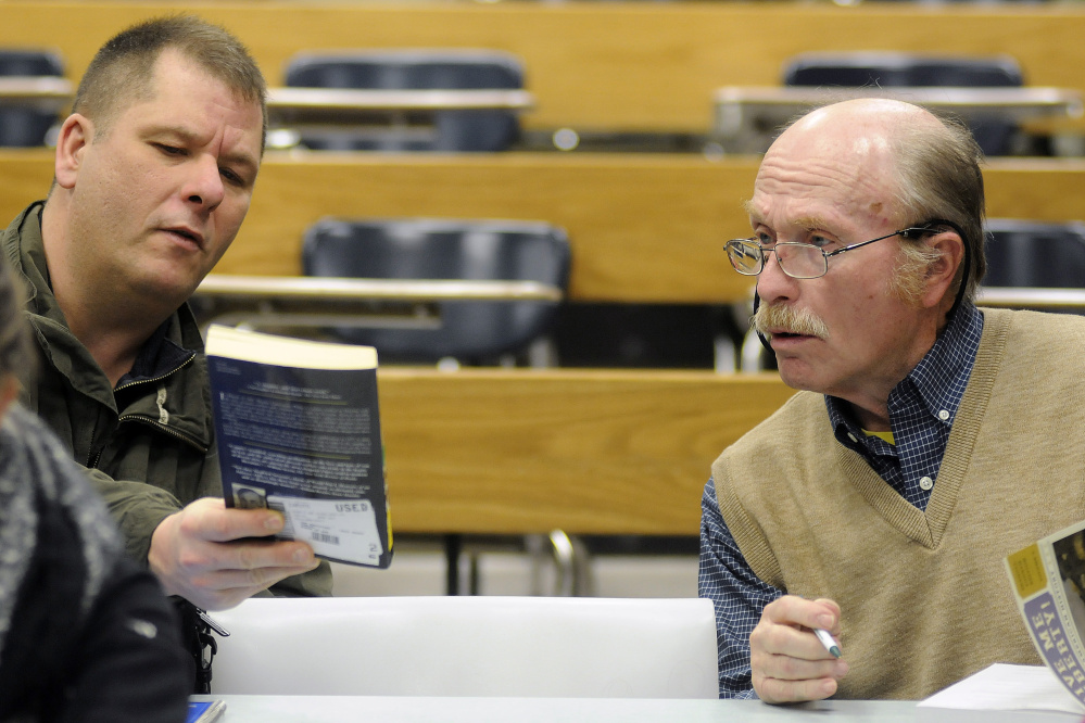 George Van Deventer, 80, right, confers last week with classmate Roland Choate during a U.S. History II class at the University of Maine at Augusta.
