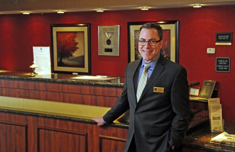 General Manager Alec Rogers stands in the lobby on Friday at the Quality Inn & Suites Maine Evergreen Hotel in Augusta, where he said security measures are a top priority for the safety of his staff and guests.