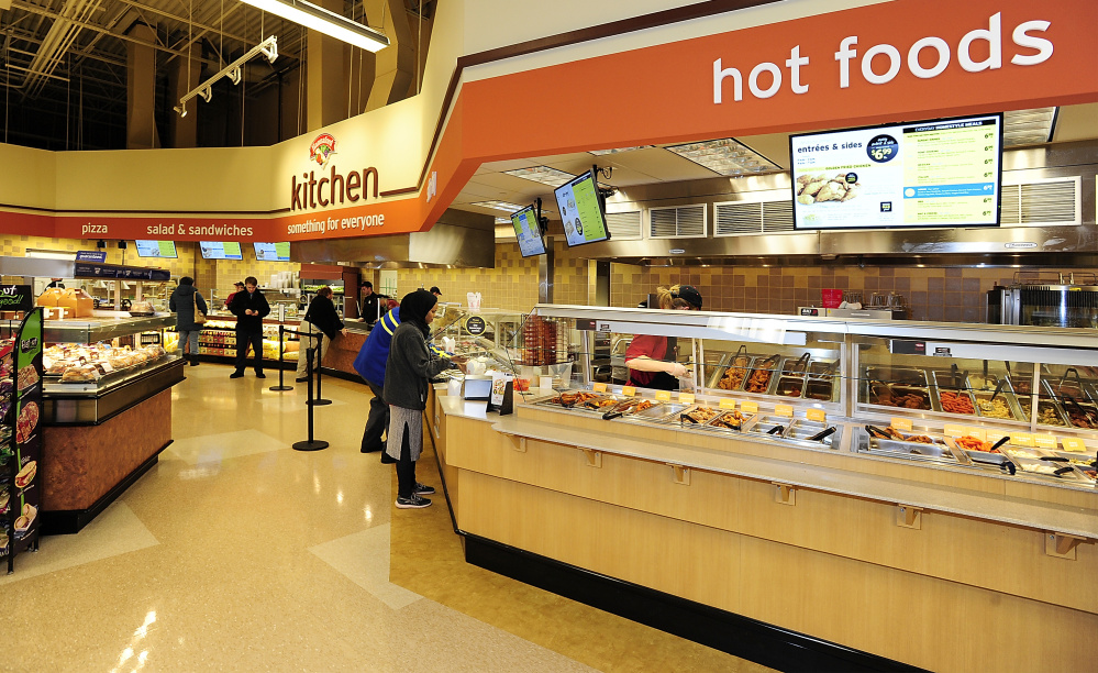 Customers select prepared food at the Forest Avenue Hannaford, where there’s also a seating area and coffee bar. Gordon Chibroski/Staff Photographer