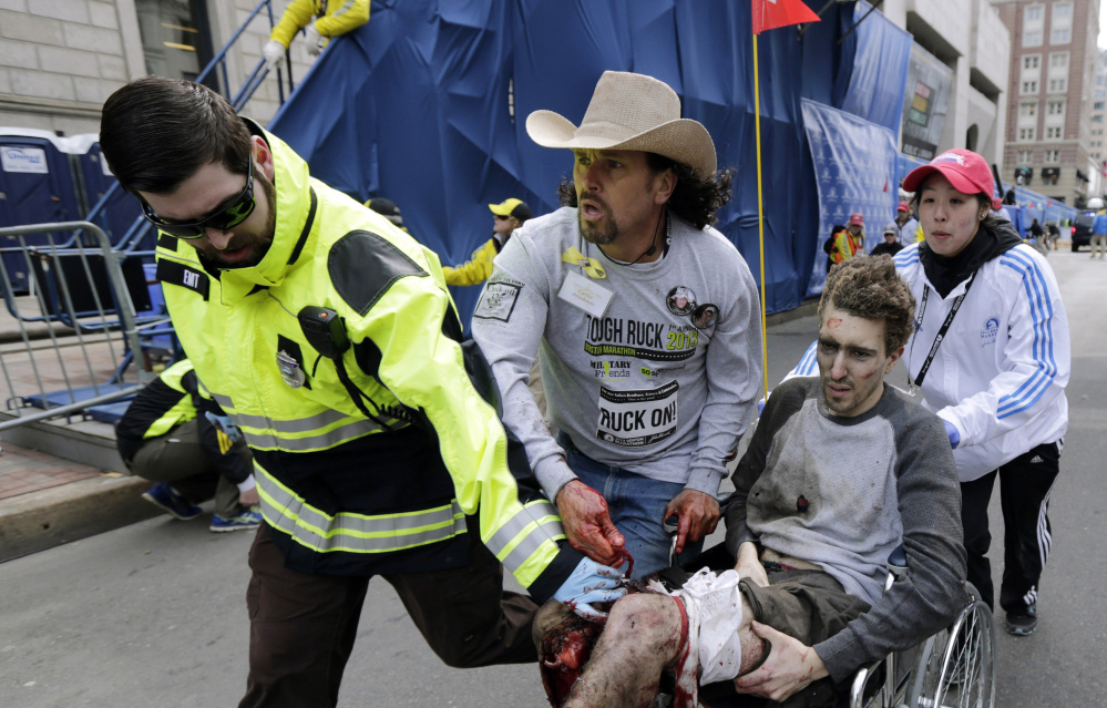 Boston EMT Paul Mitchell, left, bystander Carlos Arredondo, in cowboy hat, and Boston University student Devin Wang push Jeff Bauman in a wheelchair after he was injured in one of two bomb blasts near the finish line of the Boston Marathon in April 2013. The first feature-length documentary film highlighting historical moments of the nation’s oldest marathon is in the works, tentatively set to premiere in April 2017 in conjunction with the 121st running of the race.