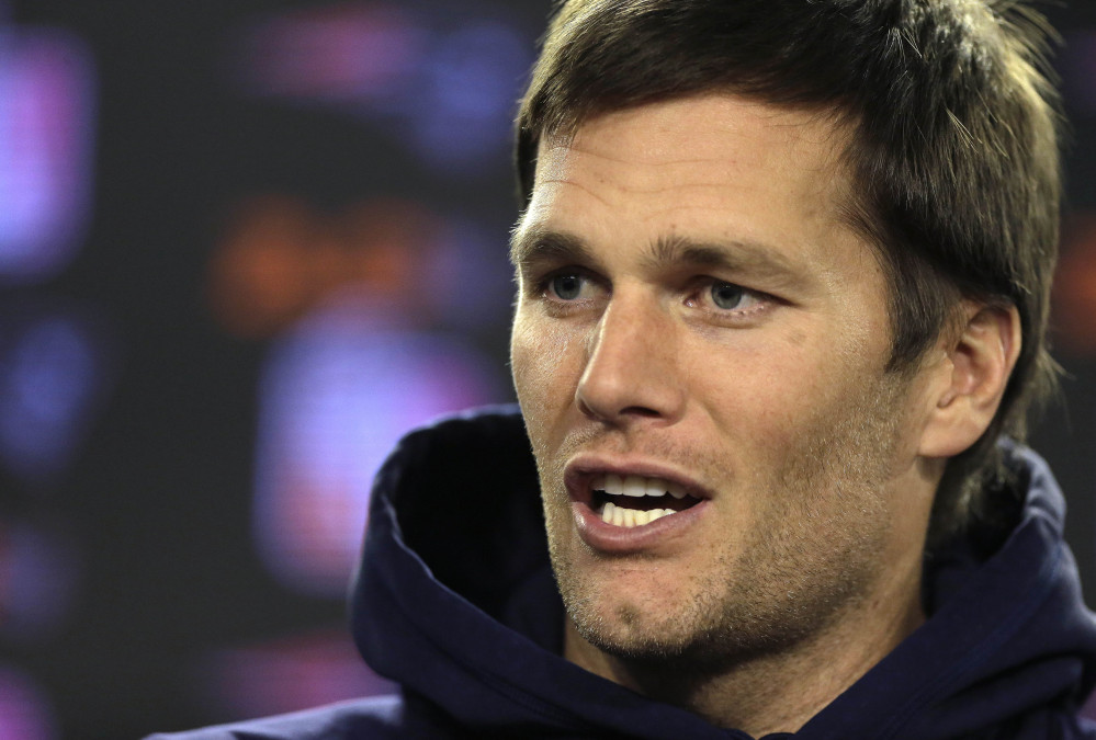 New England Patriots quarterback Tom Brady faces reporters before a scheduled NFL football practice Wednesday in Foxborough, Mass. The Patriots are to host an NFL divisional playoff game Jan. 16. The Associated Press
