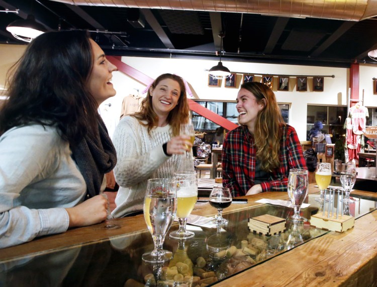 From left, Siena Mitman, Alessandra Piscina and Emily Powers sample the beer in Allagash Brewing Co.’s tasting room Wednesday. The company wants to sell prepackaged snacks to beer tasters, but that's prohibited under the city's zoning.