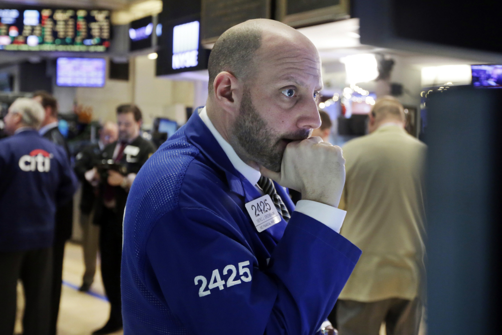 Specialist Meric Greenbaum works on the floor of the New York Stock Exchange on Thursday, as worries intensify about China’s economy and dropping oil prices.
