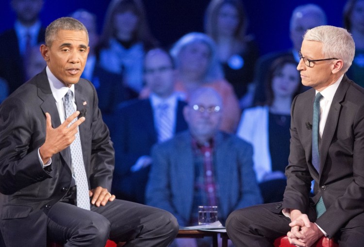 President Obama speaks about gun control during a televised CNN town hall meeting hosted by Anderson Cooper, right, at George Mason University in Fairfax, Va., on Thursday.