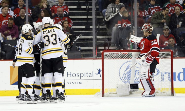 The Bruins celebrate a second-period goal by Jimmy Hayes on their way to a 4-1 win in New Jersey.