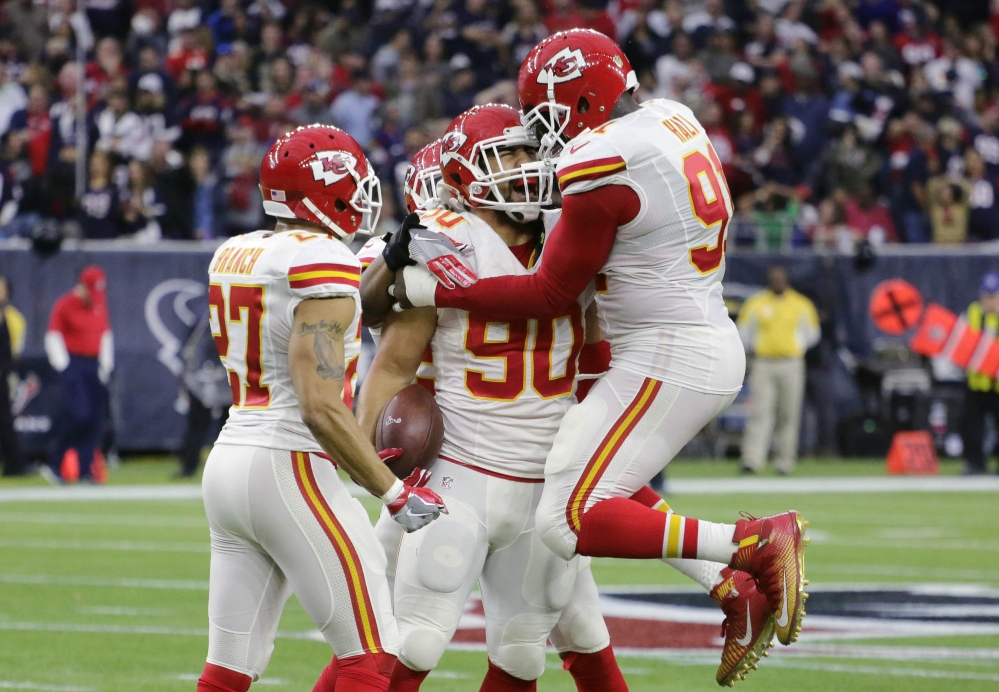 Kansas City Chiefs inside linebacker Josh Mauga, center, celebrates with teammates after he intercepted a pass thrown by Houston Texans quarterback Brian Hoyer during an wild-card playoff game Saturday in Houston.