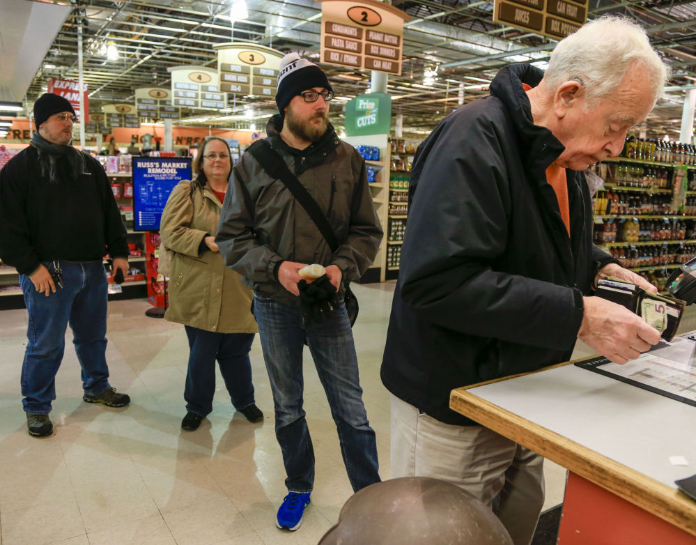 Customers stand in line to purchase Powerball tickets at Russ’s Market in Lincoln, Neb., on Monday. The Powerball jackpot grew to an estimated $1.4 billion, with Wednesday’s drawing still two days away.