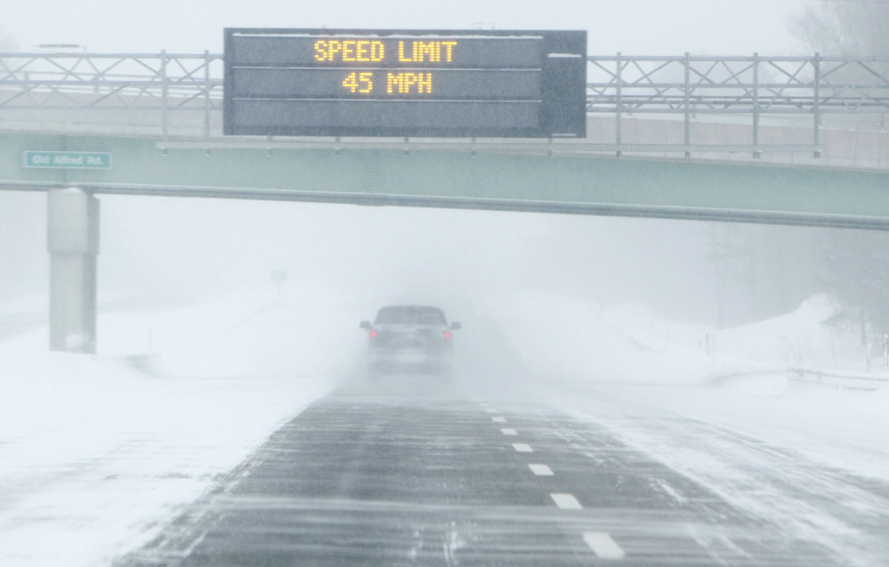 A sign on the Maine Turnpike recommends 45 mph during a snowstorm. Such signs are largely ignored, police say, but are useful for reminding motorists to use caution.