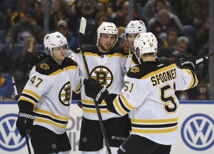 Bruins Torey Krug (47), Matt Beleskey (39), Loui Ericsson (21) and Ryan Spooner (51) celebrate a goal by Beleskey in the second period of Friday night’s win over the Buffalo Sabres.