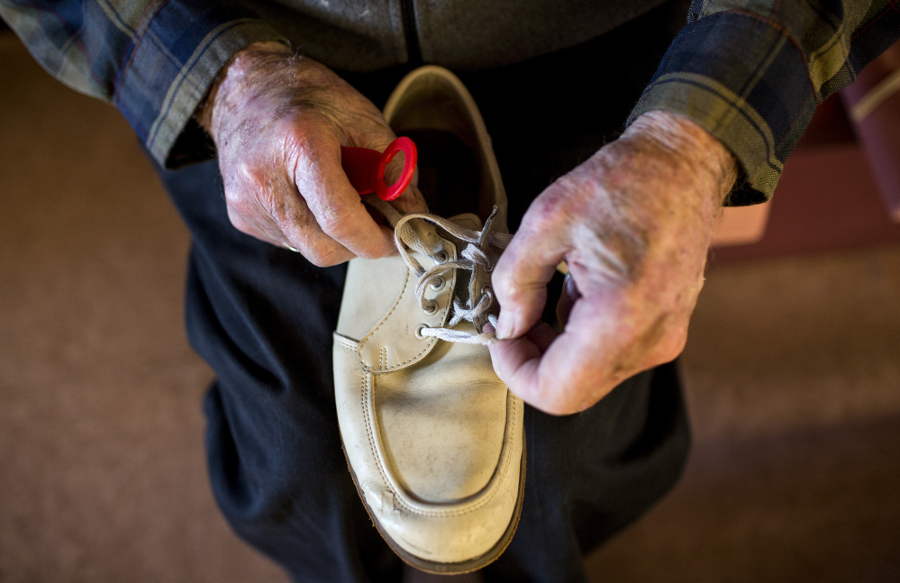Vinton Lewis adjusts the laces of his bowling shoes before rolling a few frames at the Big 20 Bowling Lanes. Lewis has bowled off and on for about 50 years.