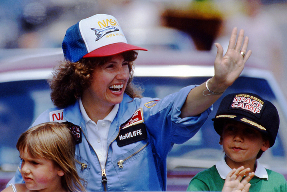 Christa McAuliffe, who was chosen to become the first teacher in space, rides with her children Caroline, left, and Scott during a parade in Concord, N.H., in 1985.